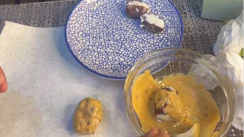 fill the dates with coconut mix and dip into peanut butter